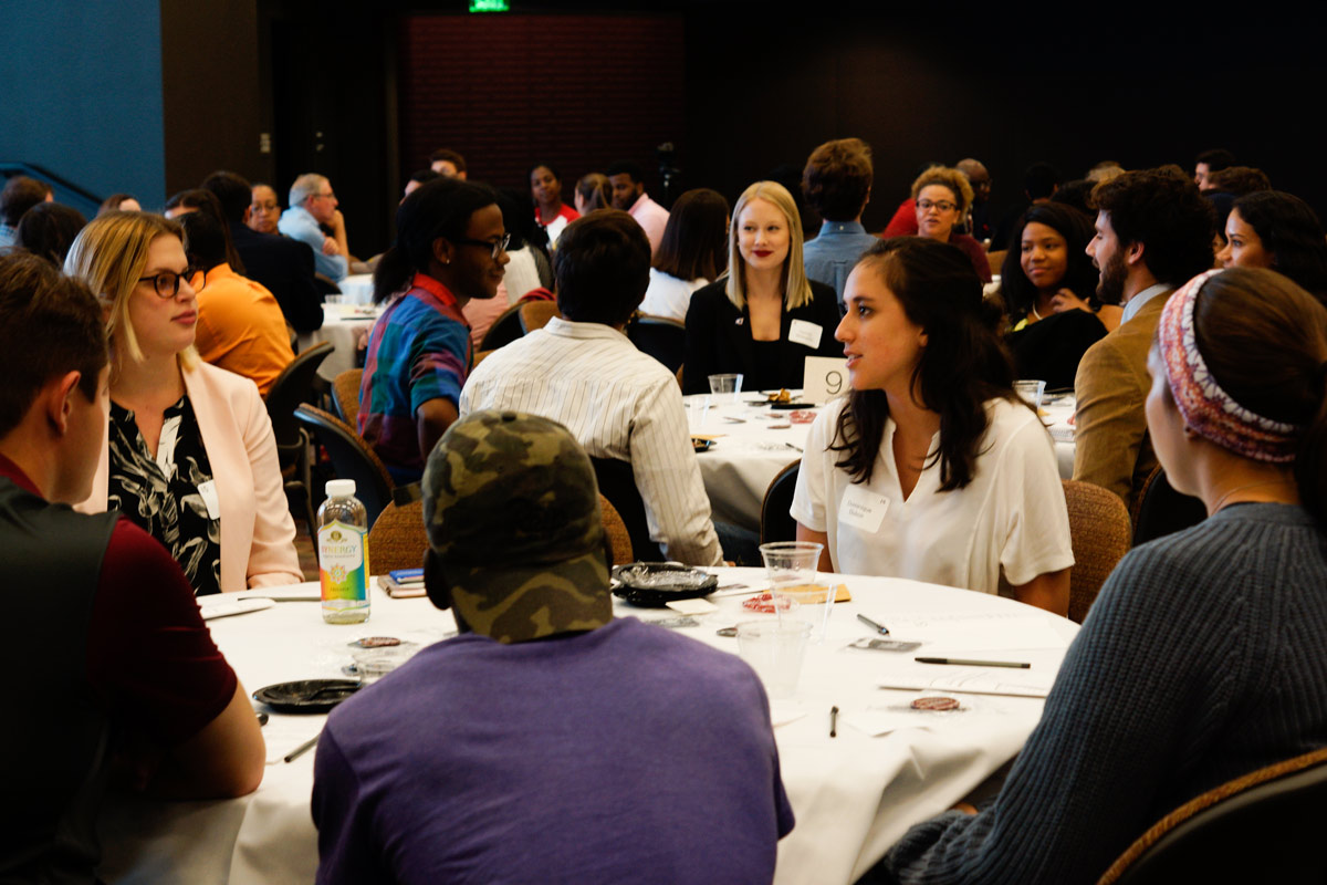 Photo of Shared Spaces Series participants chatting at their respective tables