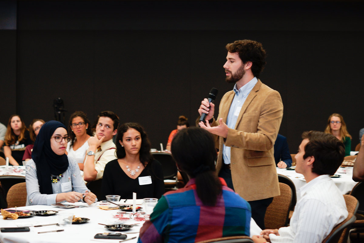 Photo of Shared Spaces Series participant asking presenters and group a question