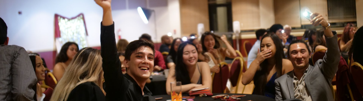 students sitting at a table during an event